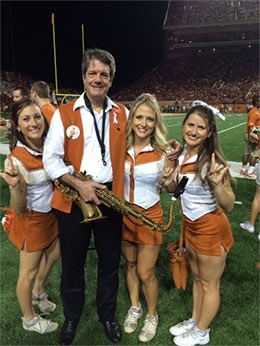 Scott with saxophone and young students